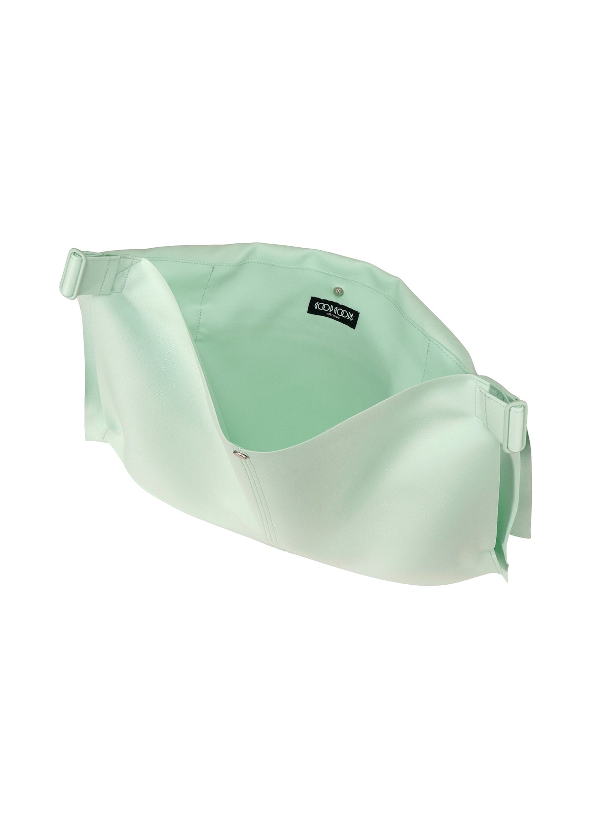 The ROLL by GOOD GOODS ISSEY MIYAKE is a light green, soft fabric crossbody bag with an elegant sheen, wide opening, adjustable side straps, and a black ICONICSON label. This lightweight bag is shown empty against a white background. view 4 of 7