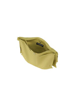 The ROLL by GOOD GOODS ISSEY MIYAKE is a light yellow shoulder bag with a wide zippered opening, fabric-lined interior, visible label, and two side knots at the top. Lightweight and stylish for daily use.