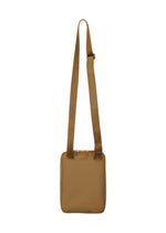 The JABARA by GOOD GOODS ISSEY MIYAKE is a tan, square-shaped pleated gusset bag with a wide adjustable strap, shown upright on a plain white background.