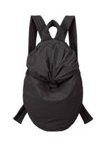 The FUWA FUWA backpack by GOOD GOODS ISSEY MIYAKE—a black, softly constructed bag with padded shoulder straps, a rounded silhouette, and a top flap closure inspired by traditional Japanese workwear—is displayed against a white background.