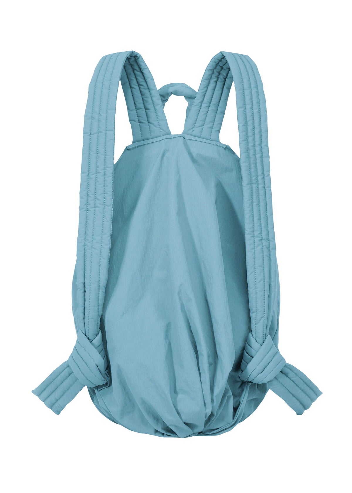 The FUWA FUWA by GOOD GOODS ISSEY MIYAKE is a light blue, soft backpack inspired by traditional Japanese workwear. It features padded, quilted shoulder straps and a simple, unstructured silhouette with a rounded bottom—embodying a thoughtful, zero-waste design philosophy. view 4 of 8