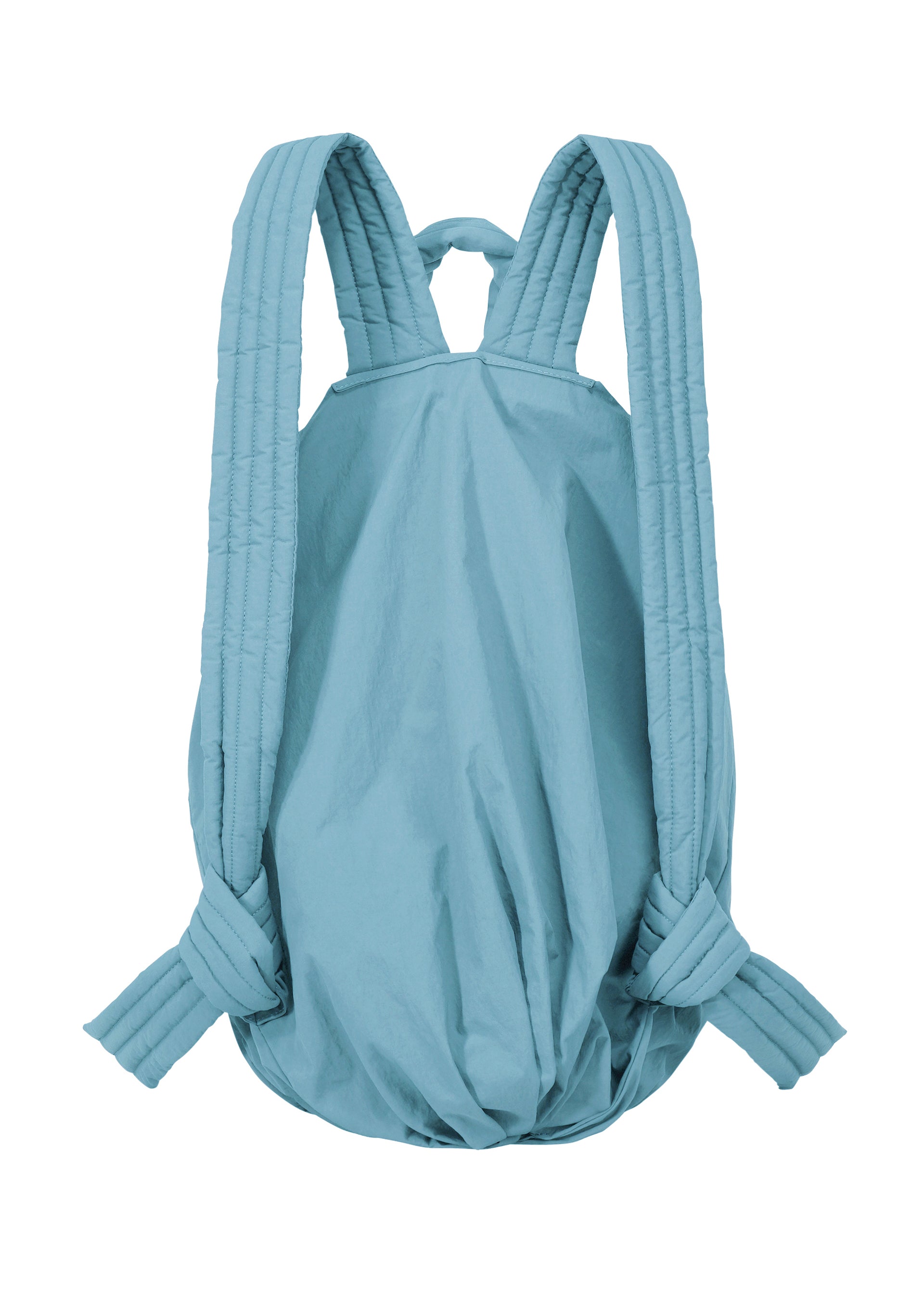 Zoomed view The FUWA FUWA by GOOD GOODS ISSEY MIYAKE is a light blue, soft backpack inspired by traditional Japanese workwear. It features padded, quilted shoulder straps and a simple, unstructured silhouette with a rounded bottom—embodying a thoughtful, zero-waste design philosophy.