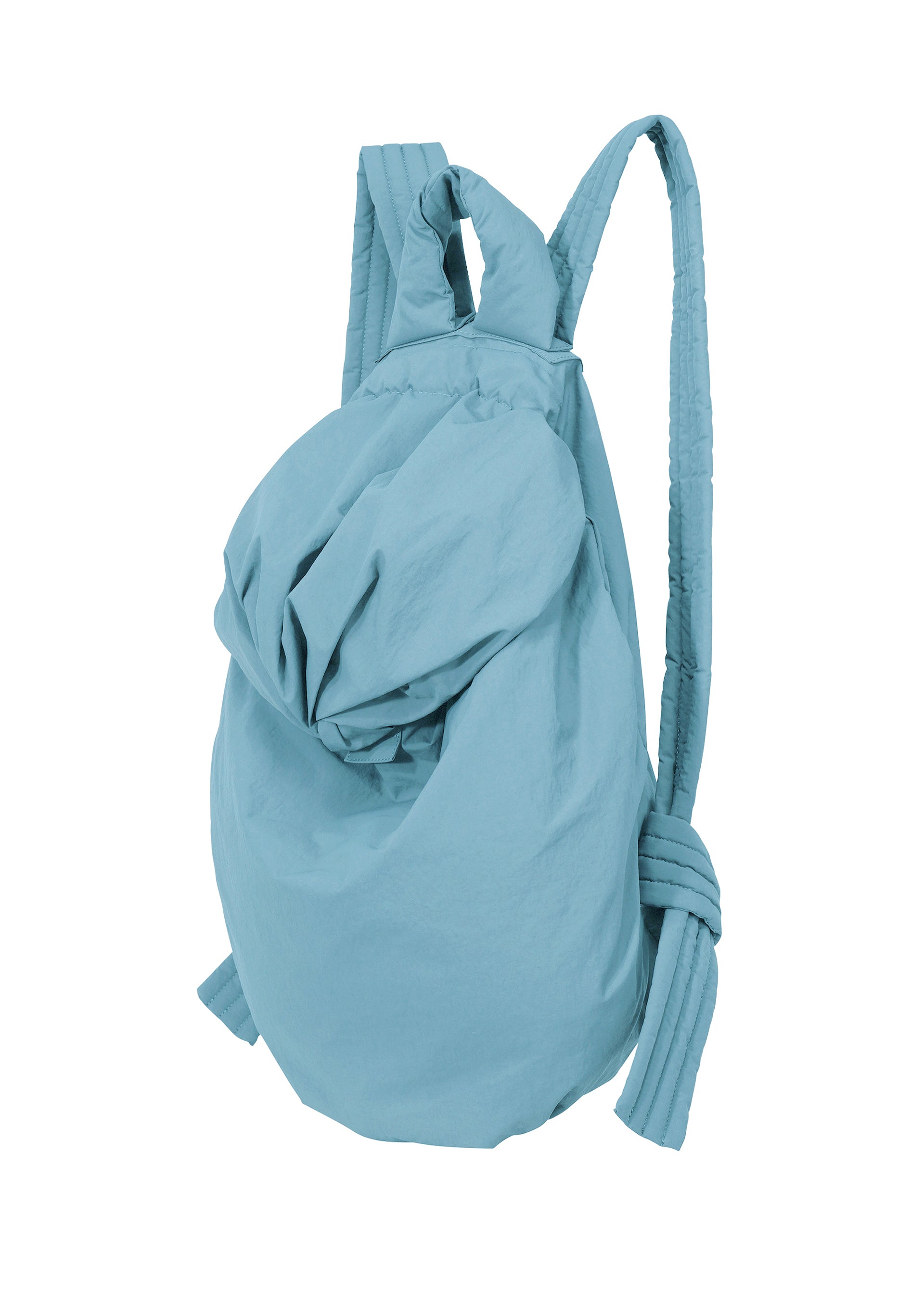 Zoomed view The FUWA FUWA backpack by GOOD GOODS ISSEY MIYAKE is a light blue, soft bag with an unstructured design inspired by traditional Japanese work clothing. It features a gathered top closure and padded shoulder straps, and is shown against a white background.