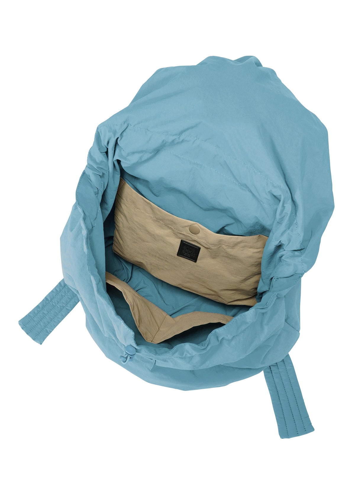 Discover the FUWA FUWA by GOOD GOODS ISSEY MIYAKE: an open, light blue soft backpack with a beige interior. It features a wide opening inspired by zero-waste design and includes an inner pocket. Bag shown empty. view 6 of 8