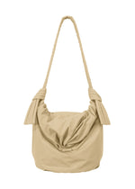 The FUWA FUWA shoulder bag by GOOD GOODS ISSEY MIYAKE is a beige fabric accessory featuring a knotted strap and a relaxed, slouchy silhouette. Inspired by traditional Japanese aesthetics and crafted with a mindful zero-waste design approach, it is shown against a white background. - BEIGE （no.41）