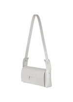 The BOX bag by GOOD GOODS ISSEY MIYAKE is a minimalist, light gray rectangular accessory featuring a long strap and a simple flap closure, showcased against a white background.