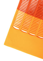 The MOKKO BI-COLOR by GOOD GOODS ISSEY MIYAKE is a knit bag with orange and yellow panels; oval cut-outs in the orange section create a striped, perforated look over the solid yellow. Ideal as a washable tote.