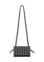 The MOKKO BI-COLOR by GOOD GOODS ISSEY MIYAKE is a small, rectangular, gray knit shoulder bag with a long double strap, textured perforated front flap, and matching strap accents on the sides for a modern minimal look.