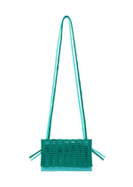 The MOKKO BI-COLOR tote by GOOD GOODS ISSEY MIYAKE features a turquoise rectangular knit design with a long double shoulder strap, woven front texture, and side ties. This washable bag stands out against a white background. - TEAL GREEN×LIGTH TEAL BLUE （no.69）