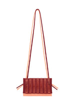 The MOKKO BI-COLOR by GOOD GOODS ISSEY MIYAKE is a stylish rectangular tote with a woven red and pink design, two long matching shoulder straps, decorative side straps, and is washable for easy care. - BORDEAUX×LIGTH SALMON （no.85）