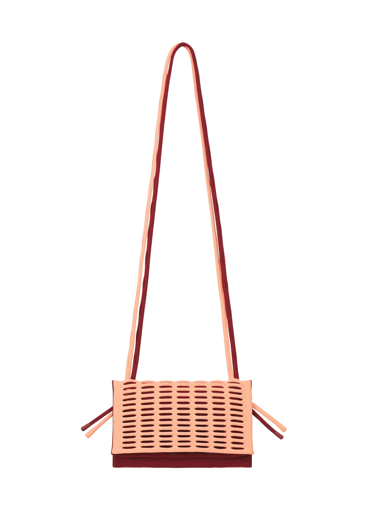 The MOKKO BI-COLOR crossbody knit bag by GOOD GOODS ISSEY MIYAKE features a rectangular shape, long strap, peach and burgundy colors, perforated front pattern, and a washable design for easy care. view 8 of 15