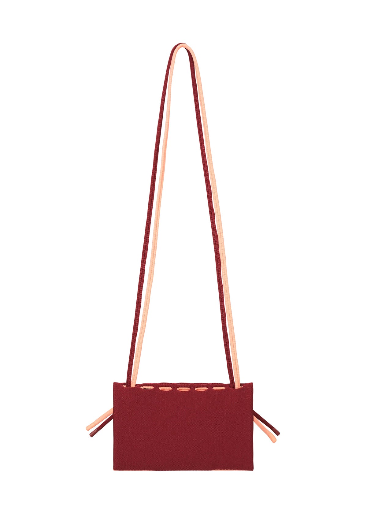 The MOKKO BI-COLOR by GOOD GOODS ISSEY MIYAKE is a rectangular burgundy knit tote with peach straps and side ties, shown on a white background. Stylish, practical, and washable. view 10 of 15