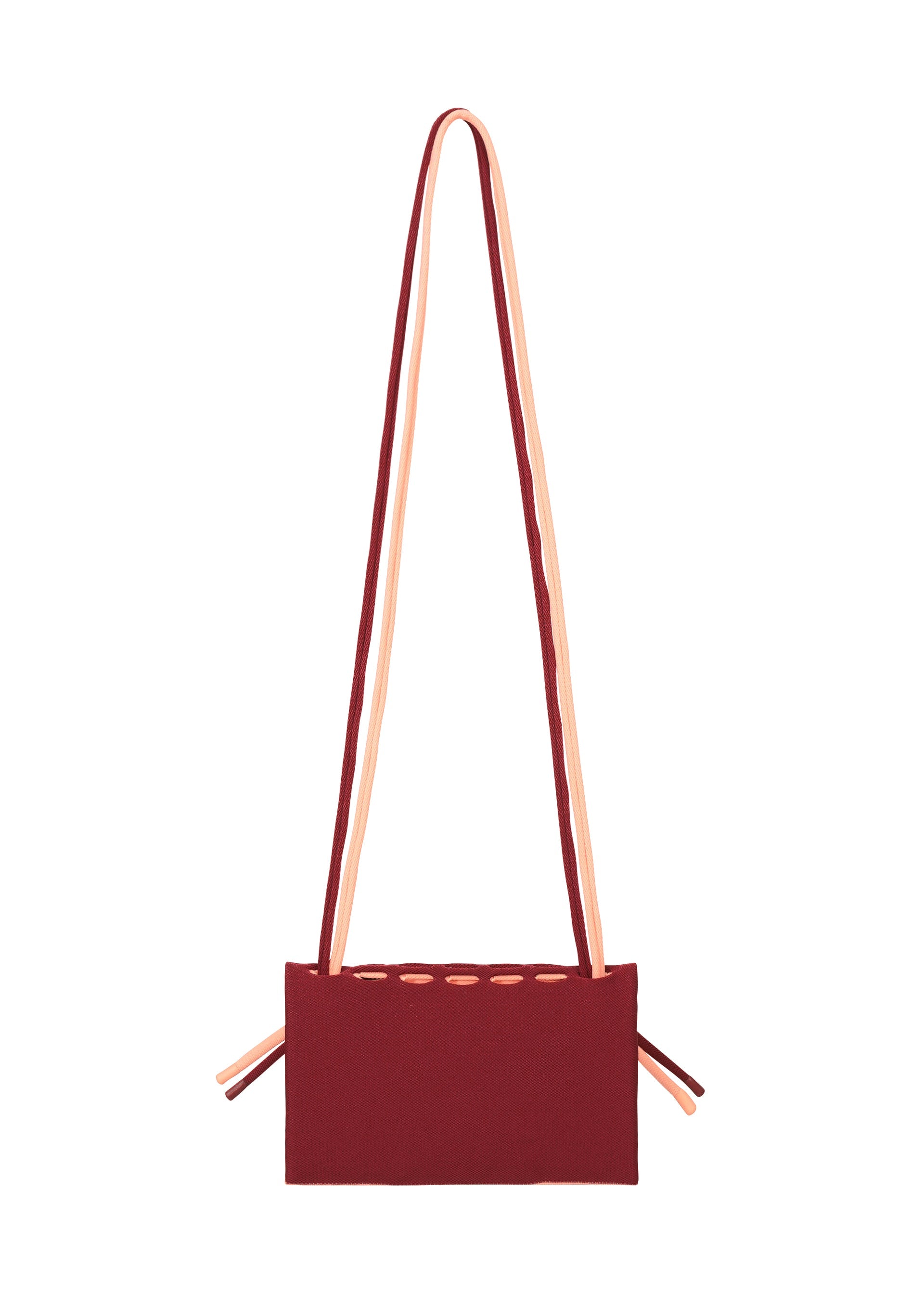 Zoomed view The MOKKO BI-COLOR by GOOD GOODS ISSEY MIYAKE is a rectangular burgundy knit tote with peach straps and side ties, shown on a white background. Stylish, practical, and washable.