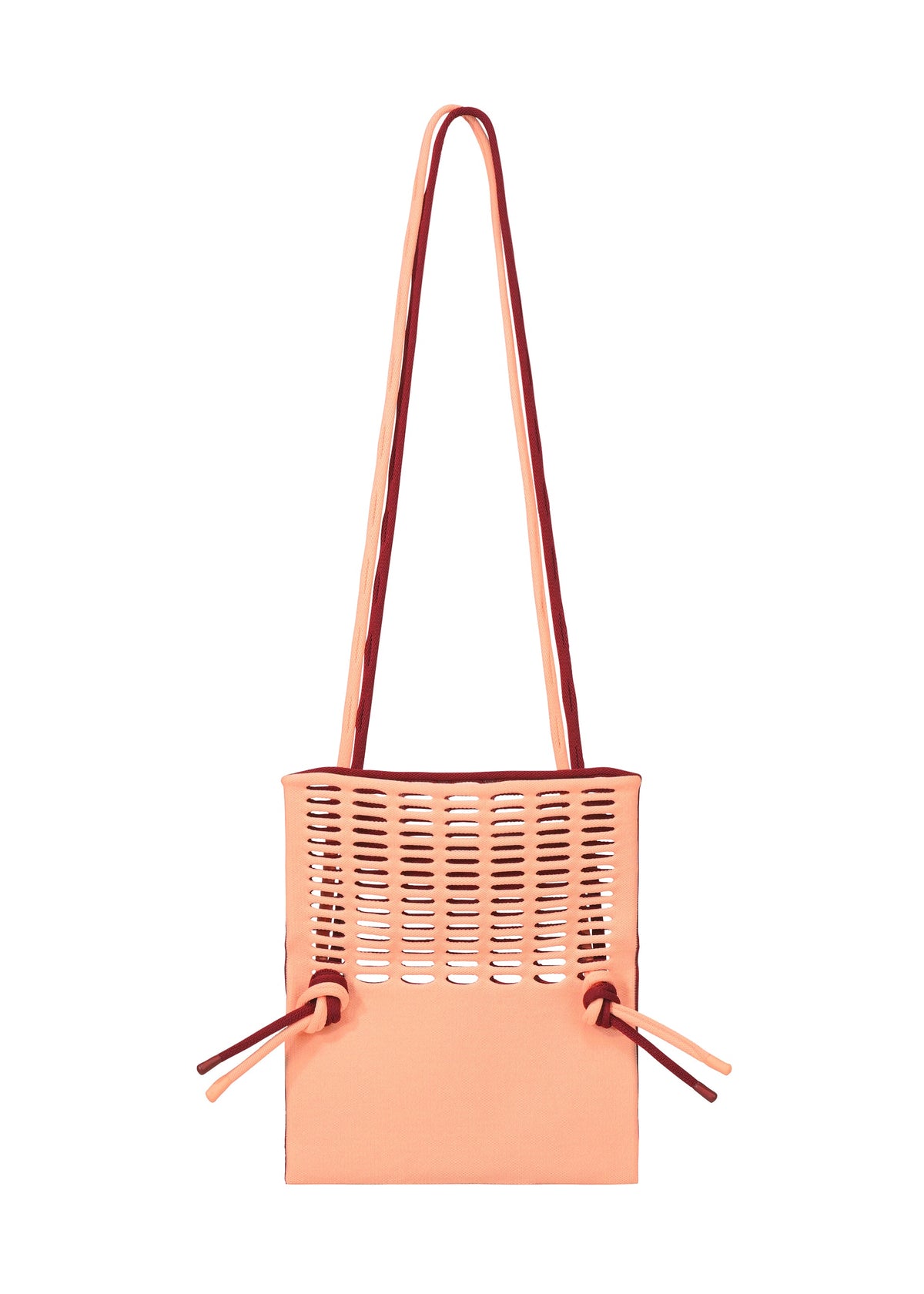The MOKKO BI-COLOR by GOOD GOODS ISSEY MIYAKE is a peach-colored washable tote featuring top cut-out slits, two long shoulder straps, and side drawstring details. view 11 of 15