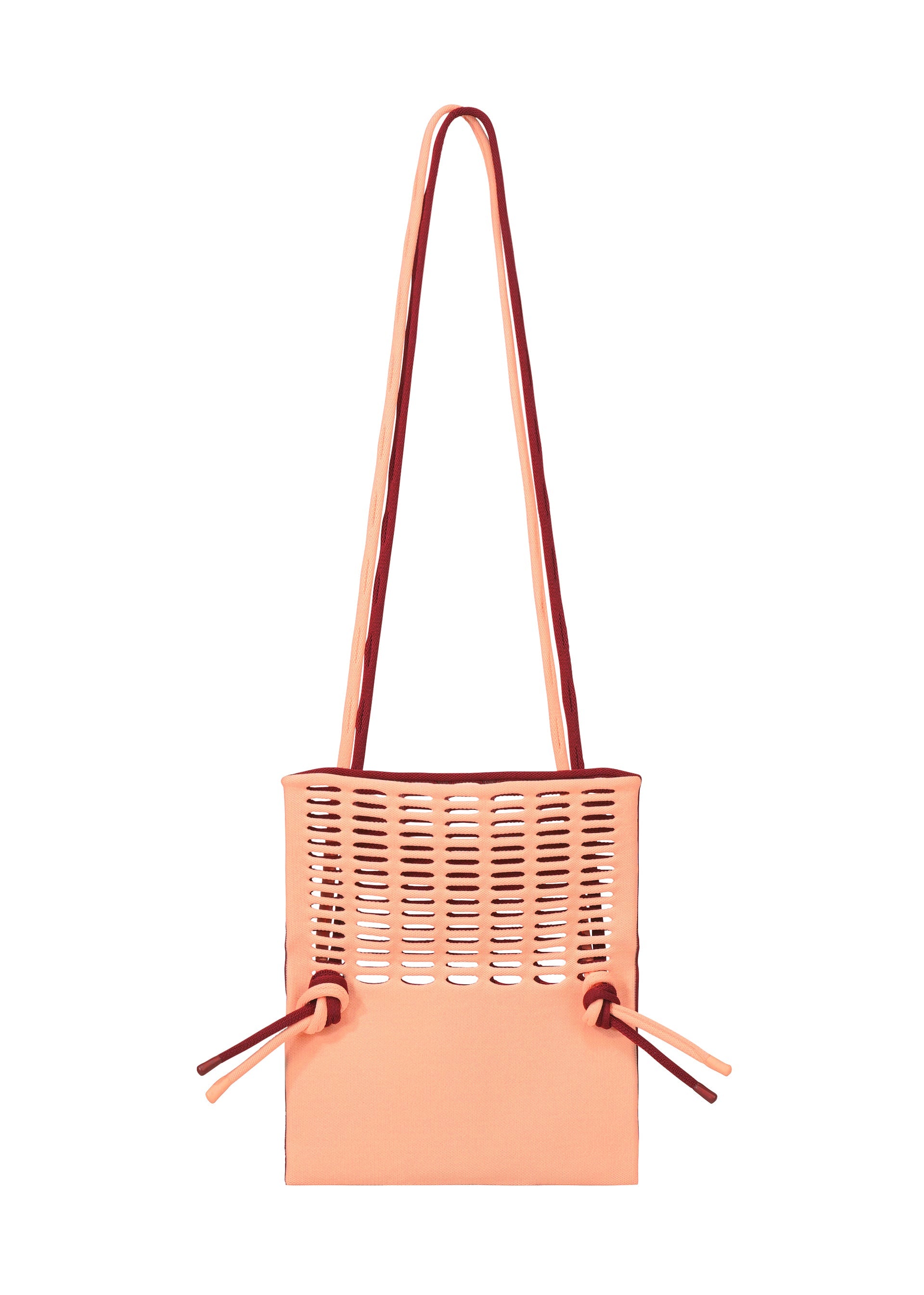 Zoomed view The MOKKO BI-COLOR by GOOD GOODS ISSEY MIYAKE is a peach-colored washable tote featuring top cut-out slits, two long shoulder straps, and side drawstring details.