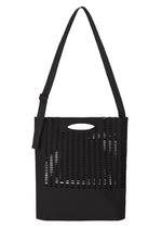 Introducing the MOKKO MONO GRIP by GOOD GOODS ISSEY MIYAKE—a black tote bag with an adjustable shoulder strap, distinguished by a perforated, grid-like upper panel, a solid lower section, and an oval cutout handle near the top. - BLACK （no.15）