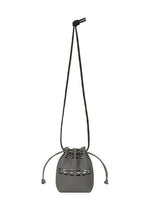 The GOOD GOODS ISSEY MIYAKE MOKKO POCKET BI-COLOR is a compact, minimalist gray pouch with a long, slim shoulder strap and metal eyelets for secure drawstring closure—blending simple style and function in a mini bag. - GRAY （no.12）
