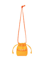 The MOKKO POCKET BI-COLOR by GOOD GOODS ISSEY MIYAKE is a small orange drawstring bag with a matching shoulder strap and cutout details, perfect for carrying your essentials in style. Set against a white background. - ORANGE YELLOW （no.31）
