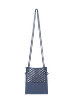 The MOKKO WASHI blue shoulder bag by GOOD GOODS ISSEY MIYAKE features a long double strap, a front panel with oval cutouts, and a simple, modern design inspired by traditional washi paper textures.