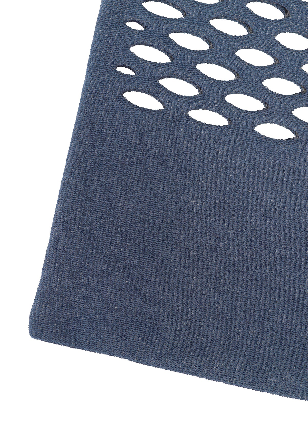 A close-up of blue textured MOKKO WASHI fabric by GOOD GOODS ISSEY MIYAKE, showing oval cutouts in rows with a white background visible through each cutout. view 10 of 13