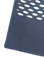 A close-up of blue textured MOKKO WASHI fabric by GOOD GOODS ISSEY MIYAKE, showing oval cutouts in rows with a white background visible through each cutout.