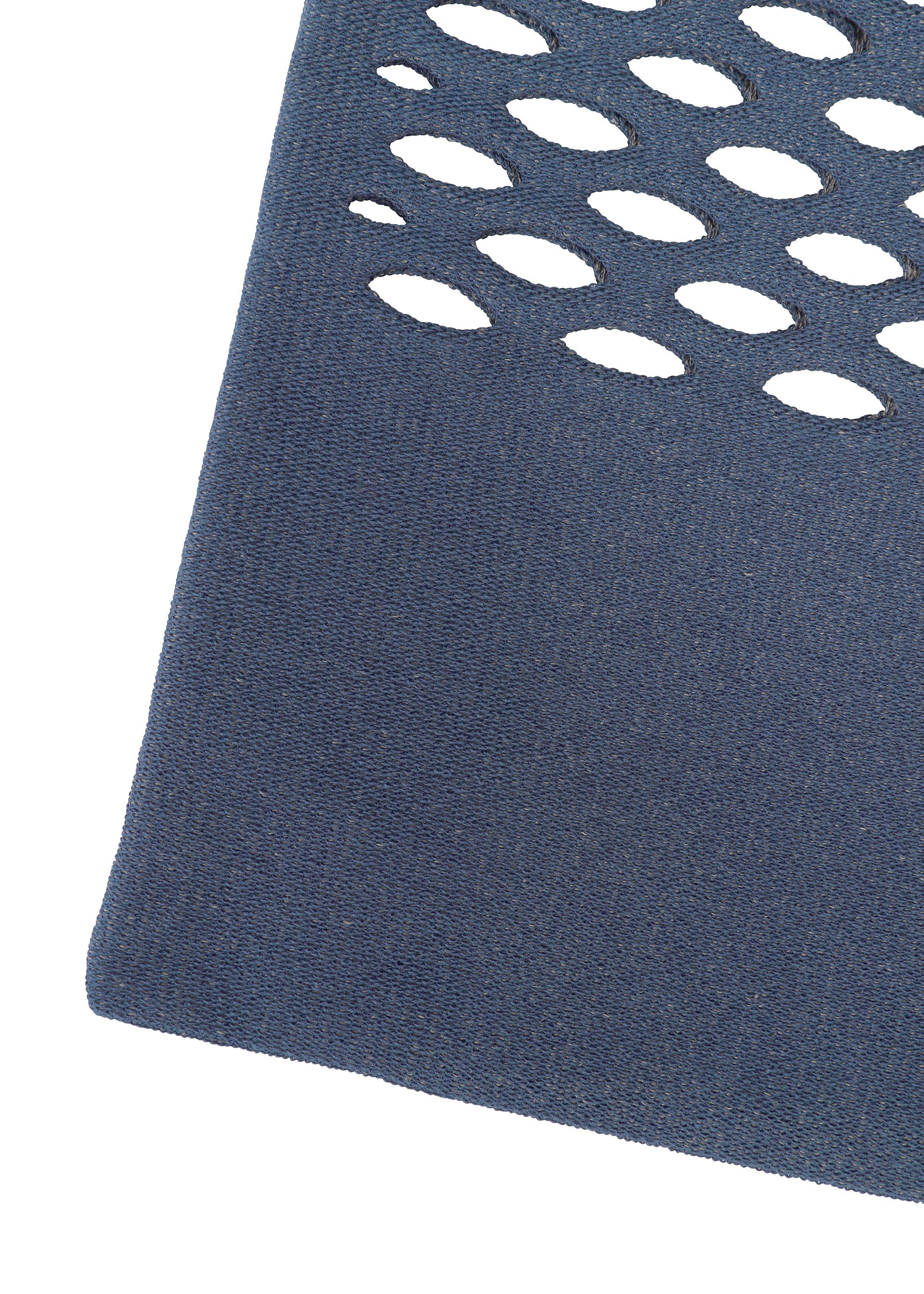 Zoomed view A close-up of blue textured MOKKO WASHI fabric by GOOD GOODS ISSEY MIYAKE, showing oval cutouts in rows with a white background visible through each cutout.