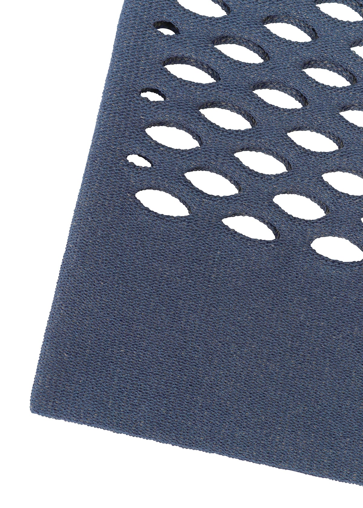 Close-up of MOKKO WASHI by GOOD GOODS ISSEY MIYAKE, showing a dark blue textured surface with oval cut-out holes in rows, evoking a washi paper tote bag, set diagonally on a white background. view 6 of 8