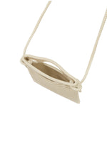 A small, beige MOKKO WALE woven crossbody bag by GOOD GOODS ISSEY MIYAKE with a long thin strap, shown from above on a white background. The bag appears empty with its top slightly open.