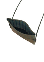 The MOKKO WALE by GOOD GOODS ISSEY MIYAKE is a small, rectangular textured pouch with wavy edges, an open top, and two side rope straps—ideal as a mini shoulder bag.