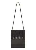 The MOKKO KNOT by GOOD GOODS ISSEY MIYAKE is a black knit crossbody bag with a long strap, rectangular shape, and a woven grid-like pattern on the upper section, contrasted by a solid lower section. - BLACK MIX （no.18）