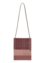 The MOKKO KNOT by GOOD GOODS ISSEY MIYAKE is a square knit shoulder bag with a long thin strap, showcasing a burgundy-beige gradient and a lattice-like MOKKO slit pattern on the upper half. - BURGUNDY MIX （no.86）