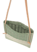The MOKKO KNOT by GOOD GOODS ISSEY MIYAKE is a green and beige knit shoulder bag with orange braided straps and a subtle MOKKO slit pattern, displayed from above on a white background.