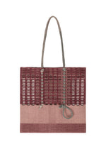 The MOKKO KNOT by GOOD GOODS ISSEY MIYAKE is a rectangular tote with two rope handles, knotted rope detail, and a woven burgundy-beige pattern. Its airy, open-knit upper adds to its unique design. - BURGUNDY MIX （no.86）