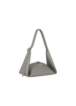The LEAF by GOOD GOODS ISSEY MIYAKE is a minimalist, light gray shoulder bag with suede-like fabric, a short strap, and zipper closure, shown upright on a white background.