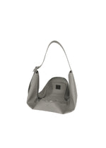 The LEAF by GOOD GOODS ISSEY MIYAKE is a gray suede-like shoulder bag with a single handle, shown open to reveal an empty interior and visible zipper against a plain white background.