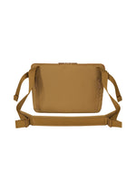 The JABARA crossbody bag by GOOD GOODS ISSEY MIYAKE is a tan rectangular accessory with two zippered pockets, adjustable straps, and a minimalist design featuring an internal laptop pocket, displayed against a white background.