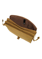 The JABARA shoulder bag by GOOD GOODS ISSEY MIYAKE is shown empty against a white background. This open tan canvas bag features a brown interior with multiple pockets and compartments, including a dedicated laptop pocket and an organized accordion pleat for added functionality.