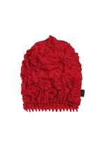 The HaaT KUMO SHIBORI KNIT is a bright red, crinkled cap made from recycled polyester, with an elastic ruffled band and a small black side tag, shown on a plain white background. - RED （no.24）