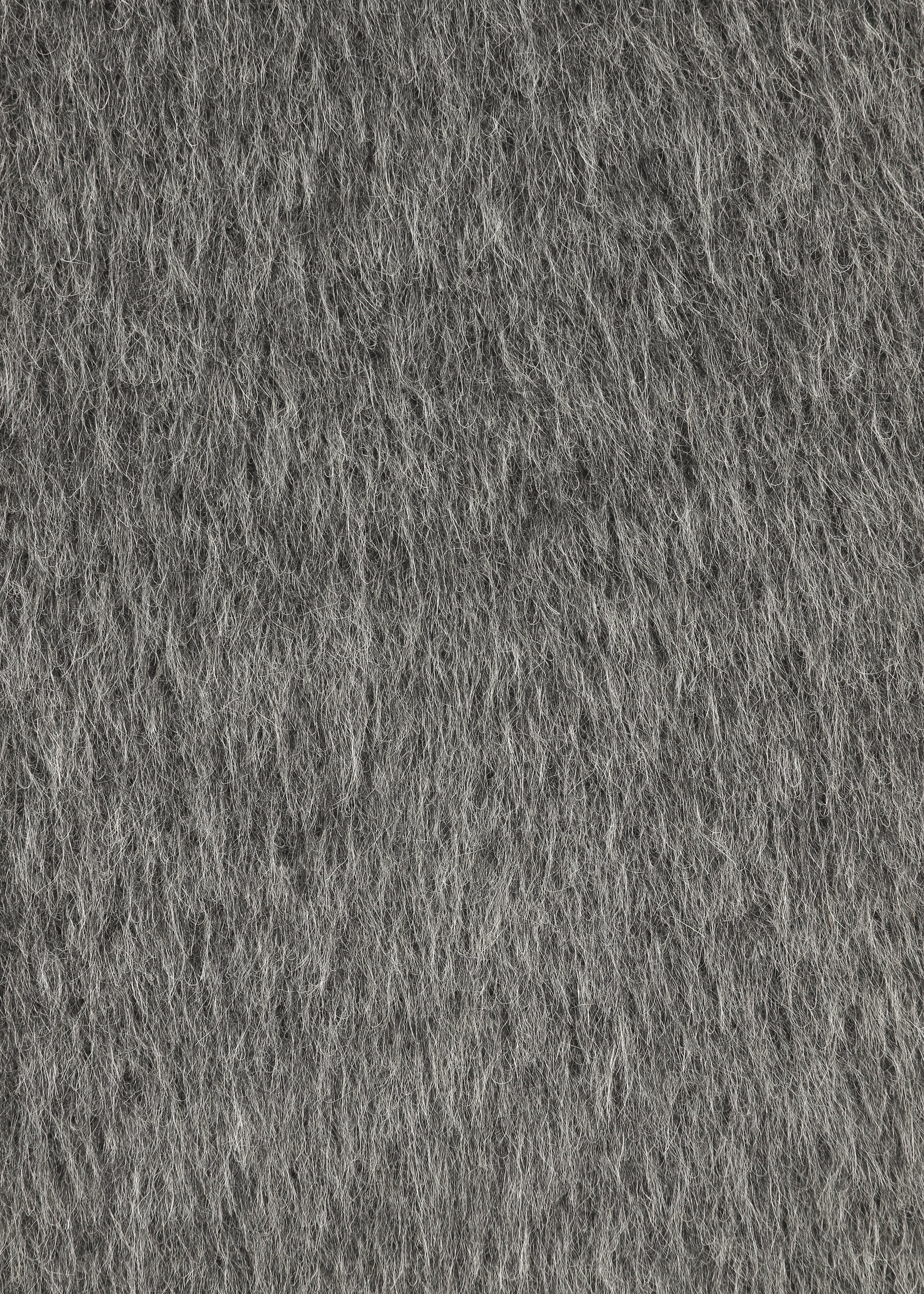 Zoomed view Close-up of HaaT’s SURI ALPACA: grey felt fabric with a dense, soft, and slightly fuzzy surface, crafted from luxurious Suri alpaca wool from Peru—ideal for a cozy long-sleeved jersey top.