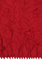 The KUMO SHIBORI KNIT by HaaT features crumpled red recycled polyester with a textured surface and gathered, ruffled hem, inspired by Kumo Shibori techniques.