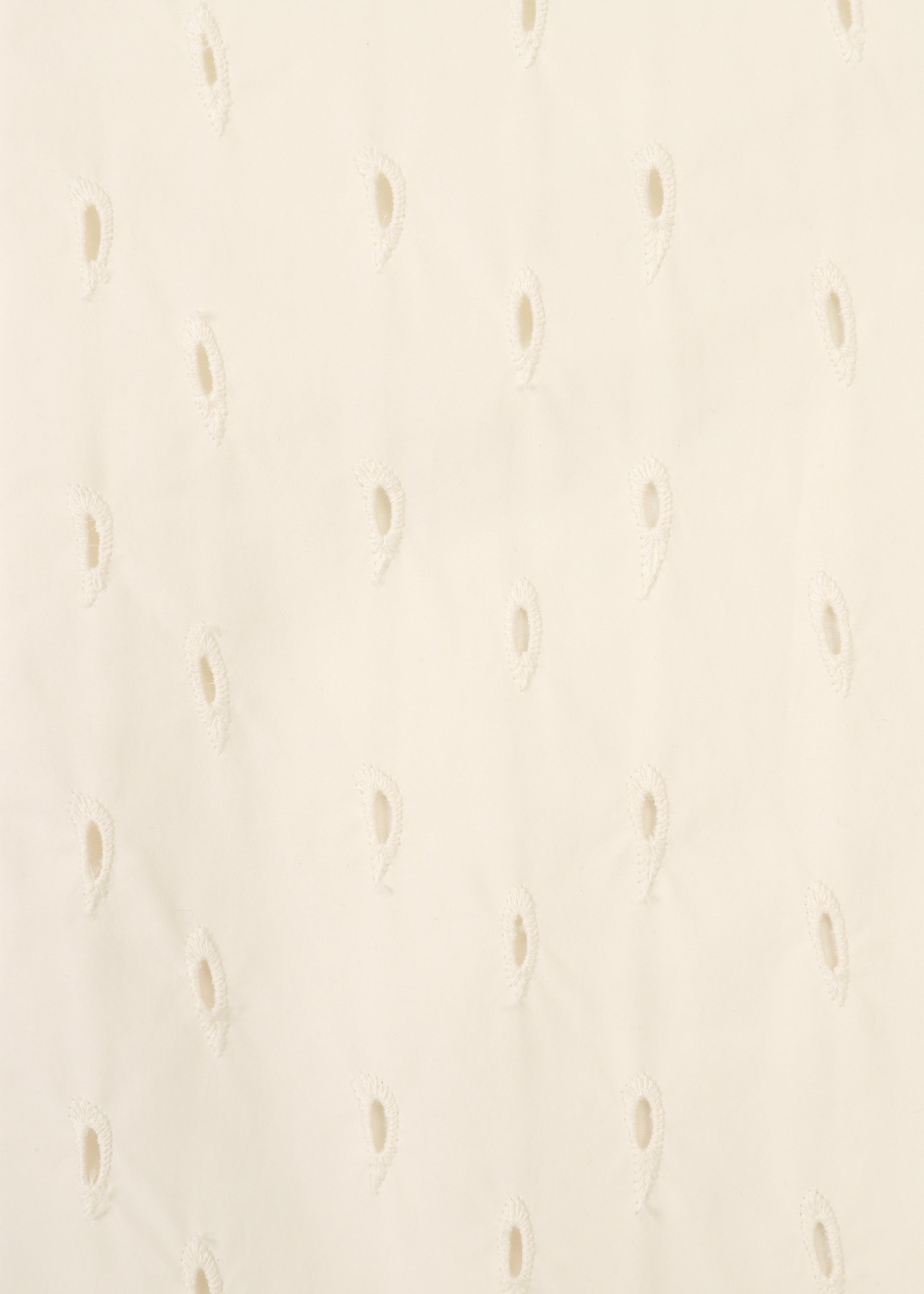 Zoomed view Close-up of TOBIKANNA fabric by HaaT, featuring off-white material with evenly spaced teardrop-shaped eyelet holes in a subtle pattern, creating a delicate and textured look reminiscent of embroidered jacket details.