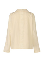Back view of the HaaT TENMOKU COTTON blouse in light cream, featuring long sleeves, a collar, subtle vertical center seams, and textured garment-dyed fabric for added depth.