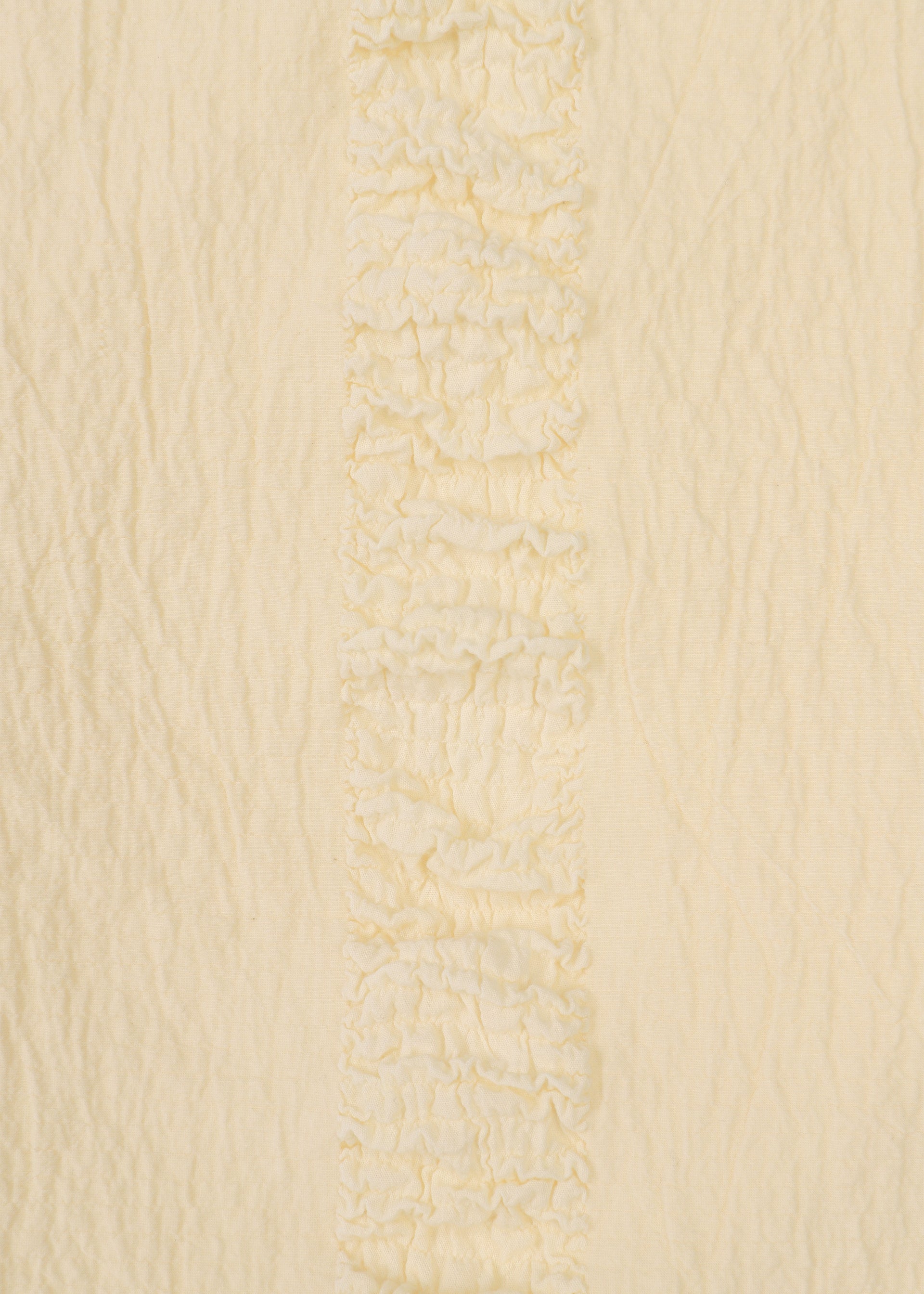 Zoomed view A close-up of HaaT's TENMOKU COTTON in cream shows gently wrinkled, soft garment-dyed fabric with a vertical textured ruffled stripe—ideal for a sleeveless top with subtle detailing.