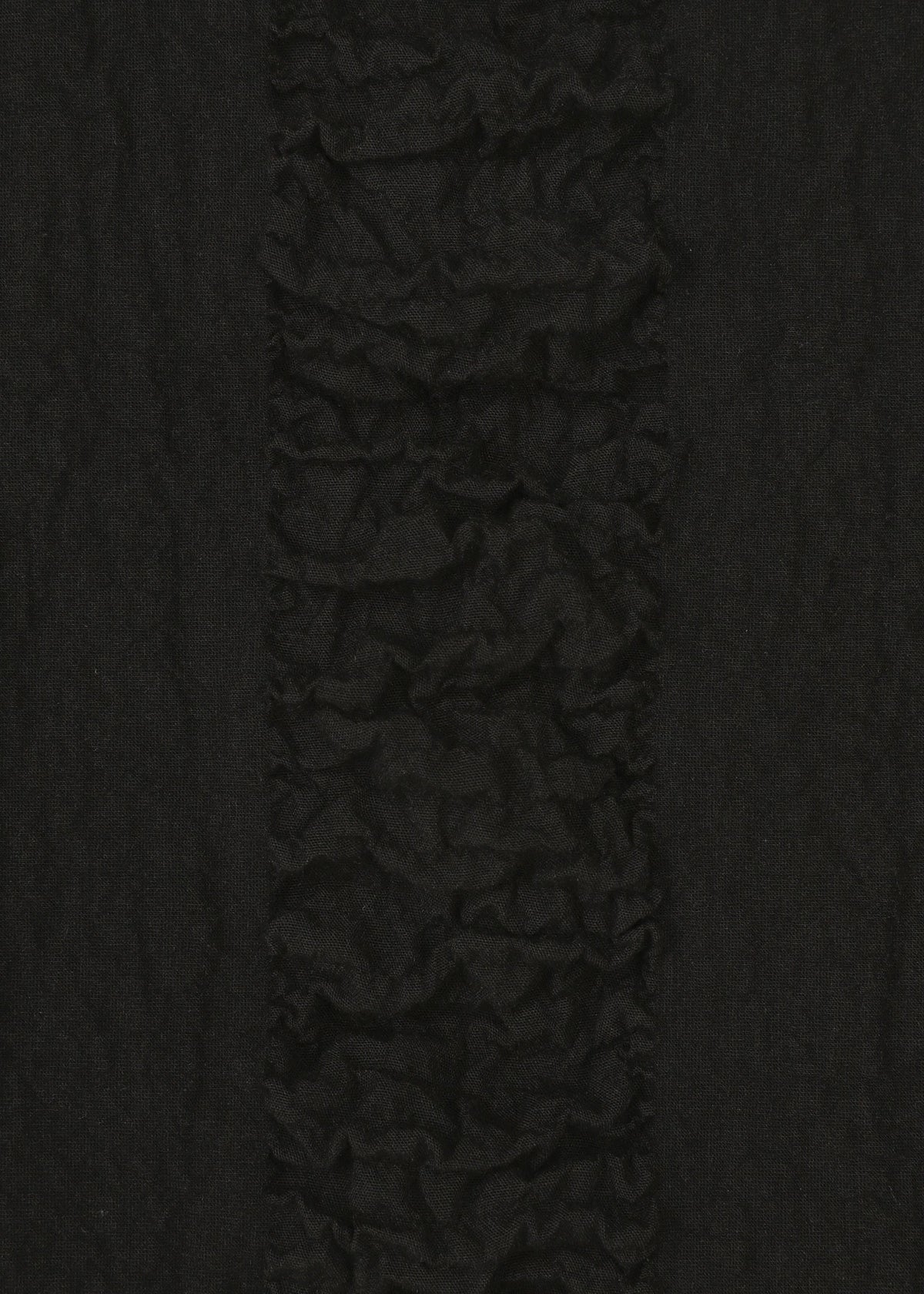 Close-up of HaaT's TENMOKU COTTON: textured black fabric with a vertical ruffled stripe and a mottled pattern inspired by Tenmoku glaze, contrasted by smoother fabric on each side. view 4 of 4