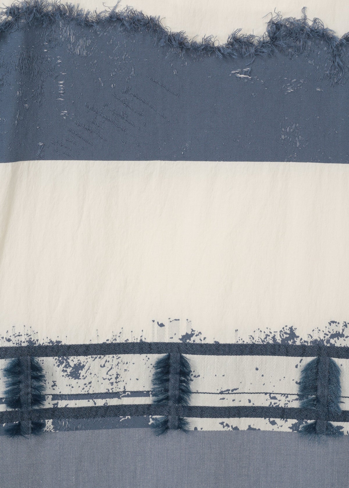 Close-up of HaaT's KASANEGAKE fabric, showing off-white and blue horizontal stripes with varied textures, distressed look, frayed edges, and a rough, painted effect. view 5 of 7