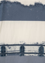 Close-up of HaaT's KASANEGAKE fabric, showing off-white and blue horizontal stripes with varied textures, distressed look, frayed edges, and a rough, painted effect.