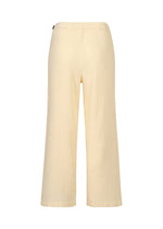 Back view of loose-fitting, pale yellow KYO CHIJIMI ITAJIME pants by HaaT, featuring an elastic waistband and wide legs in ultra-fine cotton yarn with unique loom texture, shown on a plain white background.