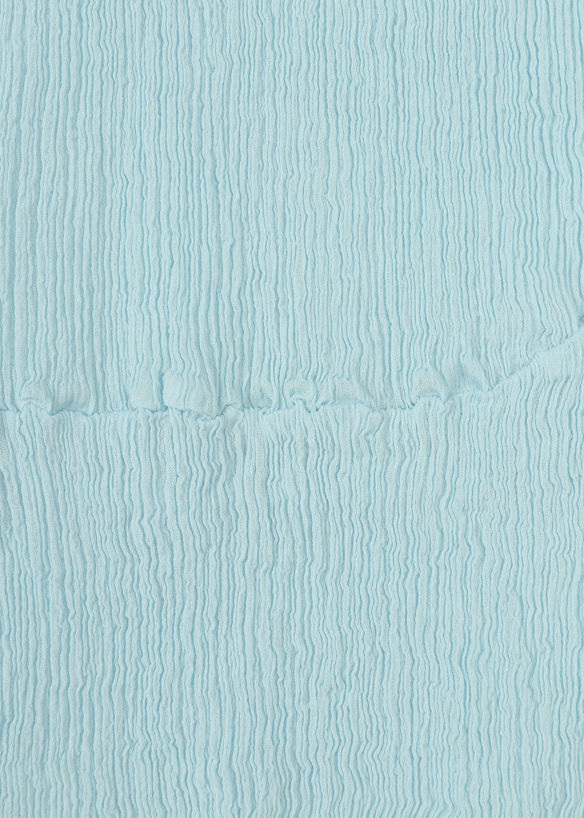 Zoomed view Close-up of HaaT's KYO CHIJIMI STREAM fabric in light blue, showing its crinkled texture with vertical lines and a visible horizontal seam across the middle.