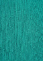 Close-up of turquoise KYO CHIJIMI EMB fabric by HaaT, featuring a crinkled light texture and vertical ribbed lines—perfect for creating a flared skirt silhouette.