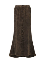 The TENMOKU COTTON skirt by HaaT features a long, dark brown silhouette with a slightly flared hem and vertical center ruffle, crafted from garment-dyed cotton for rich color and subtle texture. - BROWN （no.44）